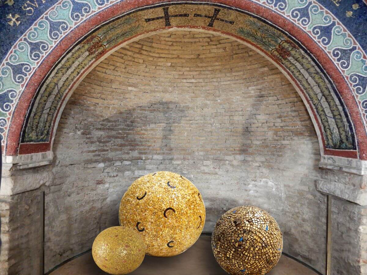 Foto di tre sfere a mosaico in tessere d'oro sotto una nicchia.